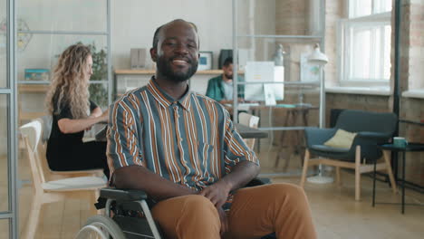 Portrait-of-Cheerful-African-American-Businessman-in-Wheelchair-in-Office